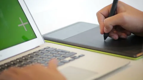 Close up of hands of a young designer using a tablet and a laptop computer Stock Footage 62802809