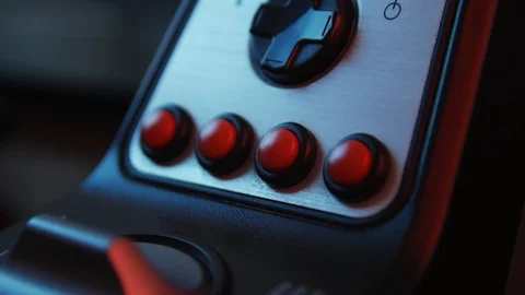 Close-up of the hands of a young gamer behind the steering wheel of a racing  Видео 113546794