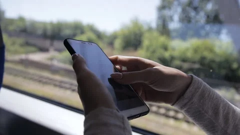 Close-up hands of a young lady using a smartphone in a train Stock Footage 114182418