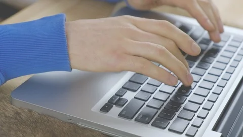 Close-up - hands of a young man are typing a message on a laptop Stock Footage 100269934