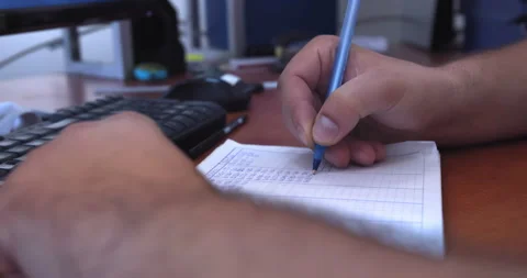 Close up of hands of young man make note with pen in notebook. Stock Footage 223972760