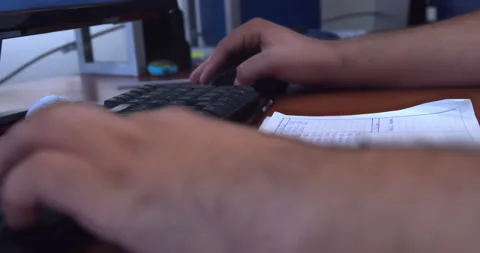 Close-up hands of young man manipulate computer mouse and type on keyboard. Stock Footage 223974588