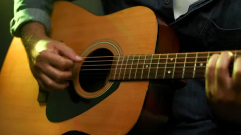 Close up hands young man playing acoustic guitar on stage live in concert. Stock Footage 162441428