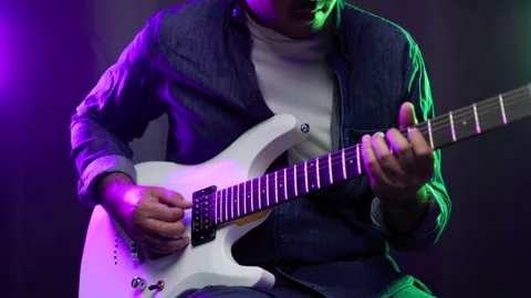 Close up hands young man rocker playing electric guitar on stage live in concert Stock Footage 162440372