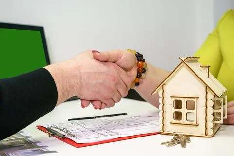 Close-up of a handshake between a man and a woman financial adviser during a 写真素材
