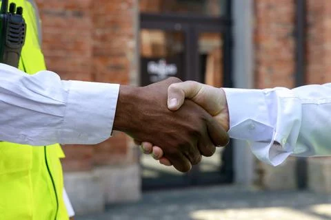 Close up of handshake between two men, caucasian architect and african american Stock Photos
