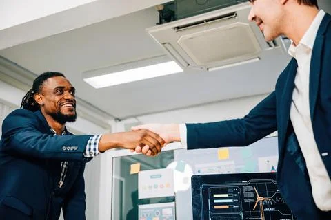 Close-up of a handshake between a young manager and a new employee, symbolizing Stock Photos