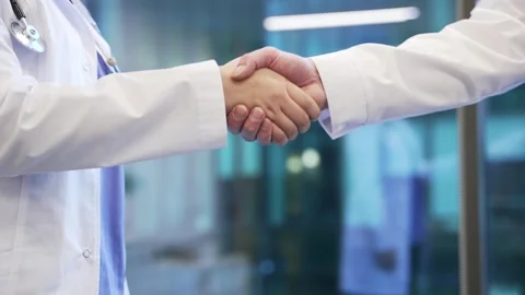 Close up of handshake of colleagues doctors symbolizing teamwork and cooperation Stock Footage 298996226