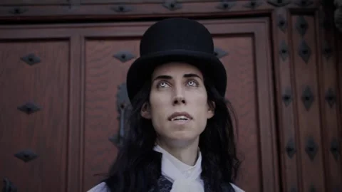 Close-up of handsome and mysterious gothic vampire with long black hair Stock Footage 284843981