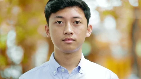 Close-up of handsome asian man looking at camera with three kind of tones Stock Footage 86140572