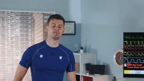 Close-up of handsome athlete walking on treadmill and smiling Stock Footage 114082391