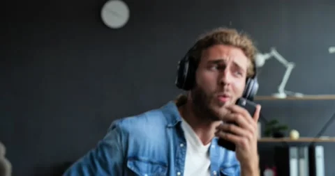 Close Up of handsome Bearded guy have Fun jumping dancing enjoying and listening Stock Footage 137600798