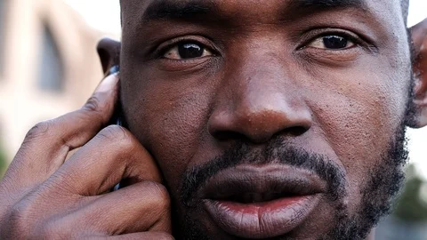 Close up on handsome black man talking by phone Video stock 88551670