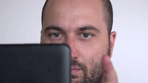 Close up handsome business man indoor sliding tablet screen working eyes rolling Stock Footage