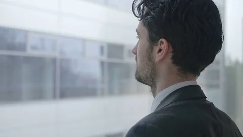 Close-up of handsome businessman looking through the window Stock Footage 75550198