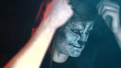 Close-up, Handsome Guy in Chen Kapyushon with the Beast's Grim on the Face Lifts Stock Footage 88447750