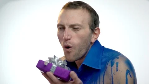 Close-up, Handsome Man in Blue Improvised Shirt Hold Gifts in Hands, Send Air Stock Footage 86260245