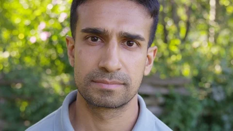 Close Up - Handsome man contemplates into the camera with a straight face, Stock Footage 125160283