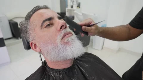 Close-up of handsome man getting his beard combed and shaped.MOV 스톡 동영상 255795823