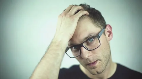 Close up of handsome  man in glasses standing over grey background. 動画素材 40803024