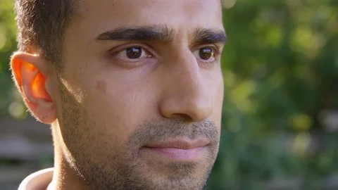 Close up handsome man looking off into the distance, contemplating life. - Slow Stock Footage 125160466