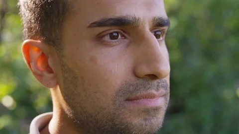 Close up handsome man looking off into the distance, smiling and nodding. - Slow Stock Footage 125160868