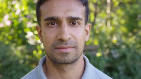 Close Up - Handsome man looks into the camera with a straight face - Slow Motion Stock Footage 125159910