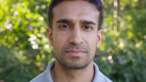 Close Up - Handsome man looks into the camera with a somber expression - Slow Stock Footage 125160004