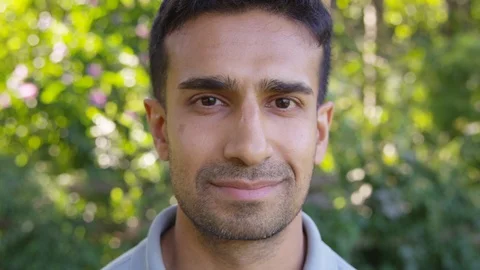 Close Up - Handsome man looks into the camera and smirks - Slow Motion - shot on Stock Footage 125160215