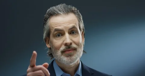 Close up of handsome senior gray-haired businessman looking at camera and Stock Footage 125467259
