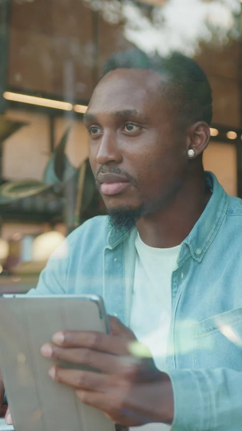 Close up of handsome serious 30-aged stylish bearded african american in casual  Stock Footage 325439351