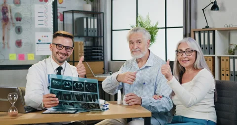 Close up of handsome smiling qualified bearded doctor with results of x-ray scan Stock Footage 160795611