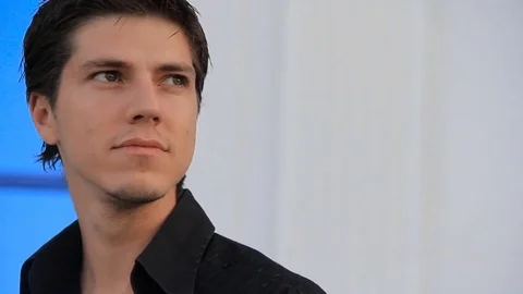 Close up of handsome young man with stylish hairstyle outdoors portrait Video stock 73827529