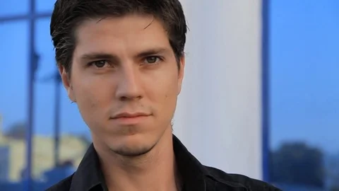 Close up of handsome young man with stylish hairstyle outdoors portrait Video stock 73827685
