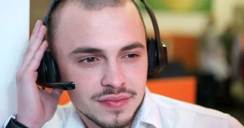 Close-up of a handsome young man working as a call center operater Stock Footage 67274735