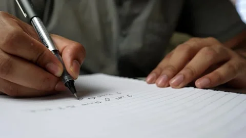 Close-Up of Handwriting in Notebook, Close-up of a person writing in a note.. Stock Footage 317736914