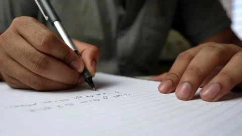 Close-Up of Handwriting in Notebook, Close-up of a person writing in a note.. Stock Footage 317736920
