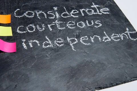 Close up of handwritten educational values: considerate, courteous and inde.. Stock Photos