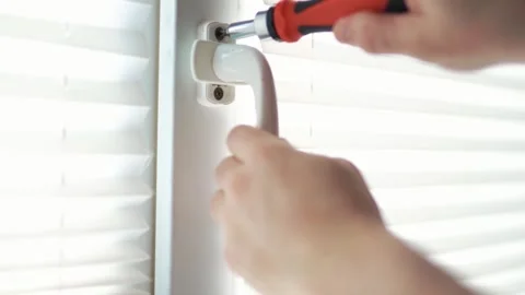 Close up of a handyman using a screwdriver to fix or install a white plasti.. Stock Footage 340159510