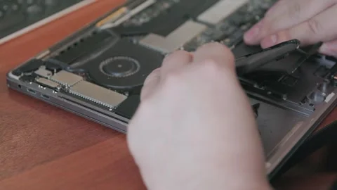 Close-up of a handyman's hands carefully removing an old faulty battery from a Stock Footage 335389088