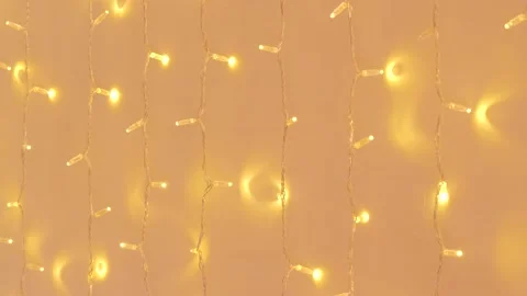 Close up of hanging chain of lights against white wall during party inside Stock Footage 167322728