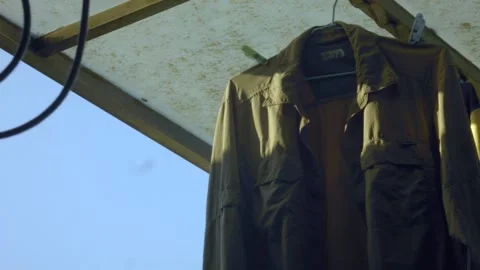 Close up of hanging cloth jacket coat swing in the wind Video stock 179515123