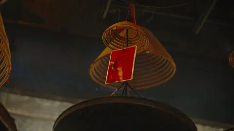Close up of hanging incense coils with red prayer tags in Chinese temple Stock Footage 297735147
