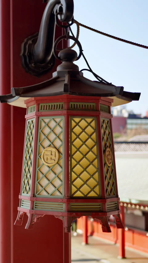Close up of a hanging lantern with a blurred view of people walking at the Stock Footage 309658110