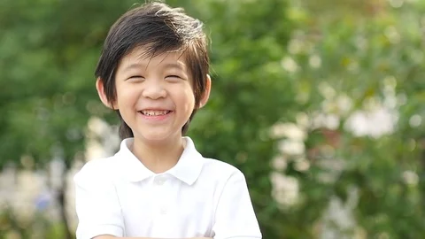 Close up of happy asian child outdoor slow motion Stock Footage