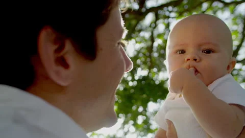 Close Up Happy Baby Held High Young Father Sun Flare Stock Footage 273580221