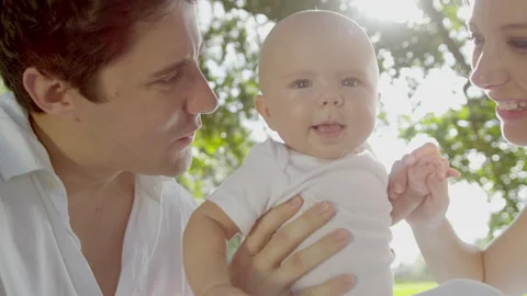 Close Up Happy Baby Held Young Parents Sun Flare Stock Footage 273577329