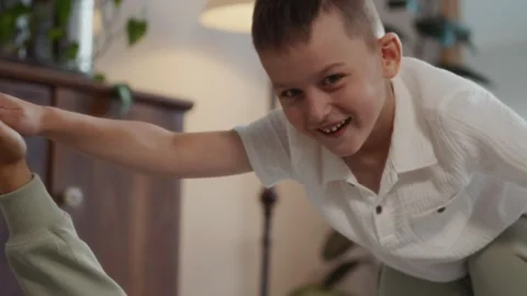 Close up of happy boy playing airplane game with mother at home Stock Footage 315748916