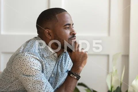 Close up happy calm young african american thoughtful guy. Stock Photos