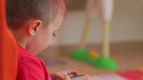 Close up of happy child using smartphone. Dolly shot Video stock 64325328